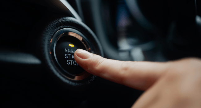 Close-up view of an Audi dashboard with speedometer and control knobs, showcasing modern automotive design and technology in a sleek interior environment.