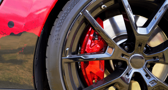 An alloy wheel with calipers and racing brakes on a Porsche sports car in Charleston, SC.