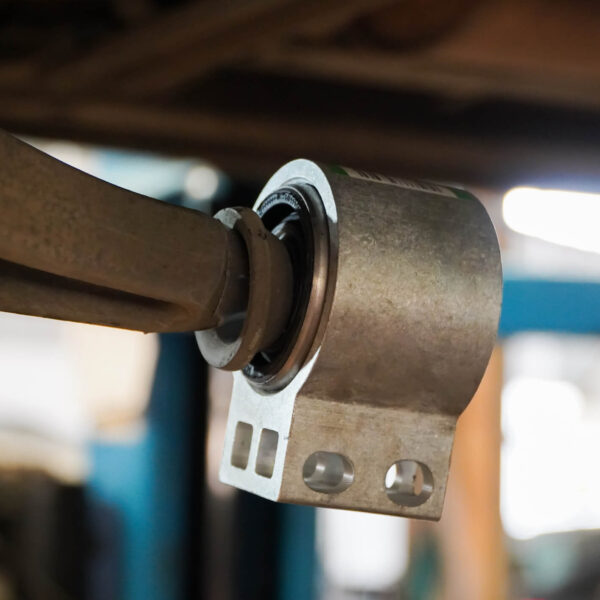 Close up of vehicle's control arm bushing.